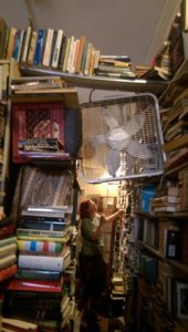 A bridge of books over the other books. The fan isn't supported by anything but wishful thinking.